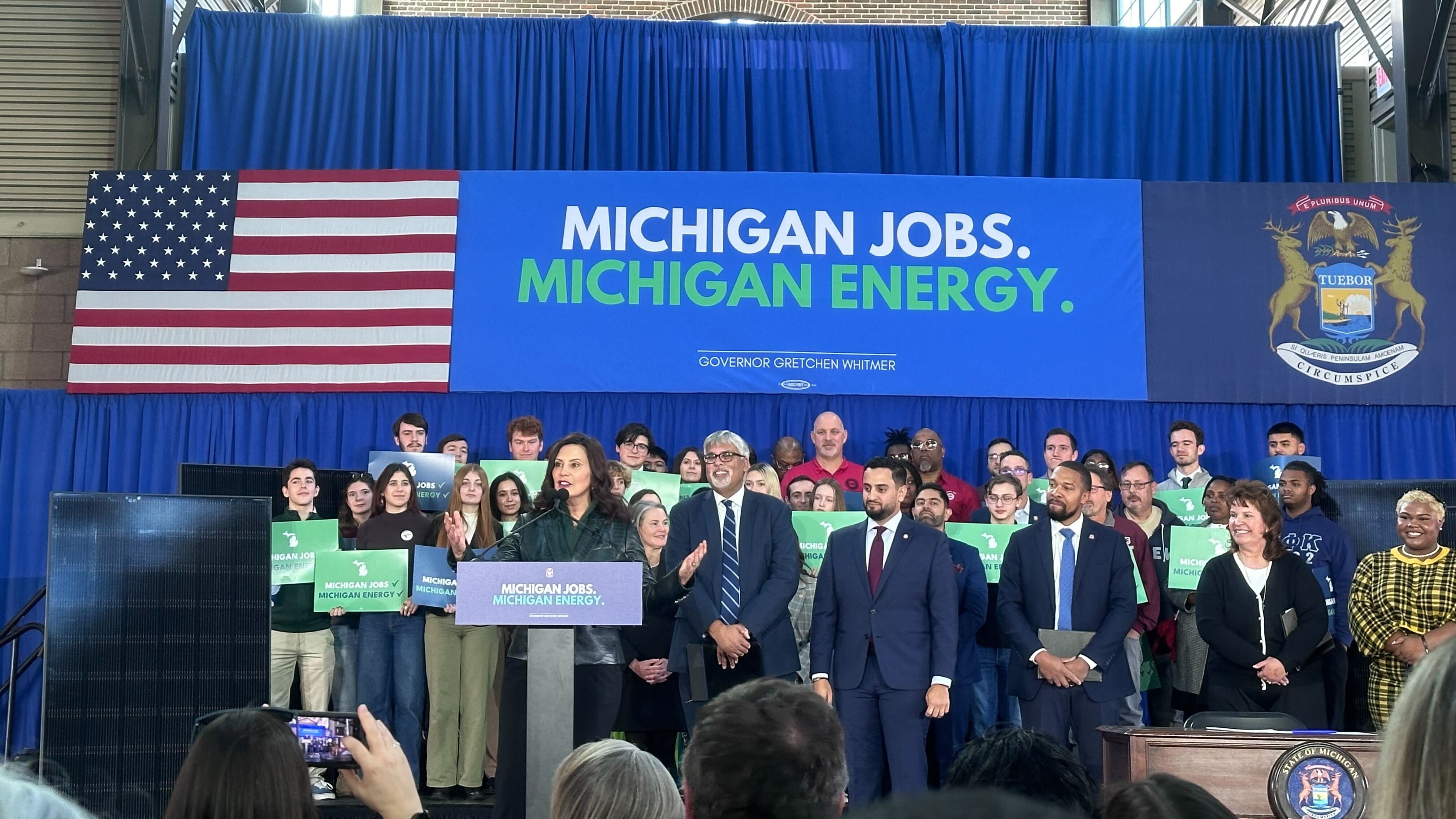 Governor Whitmer speaking on stage on the day of the bill signing.
