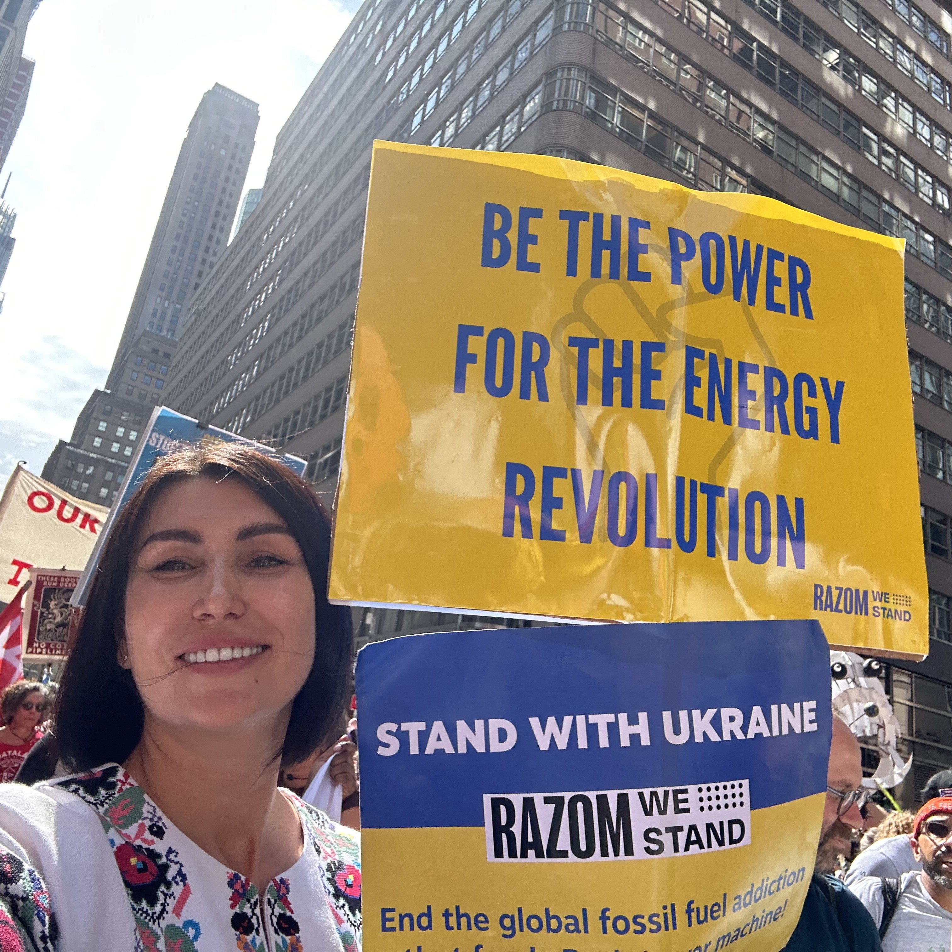 Svitlana Romanko holding a sign that says 