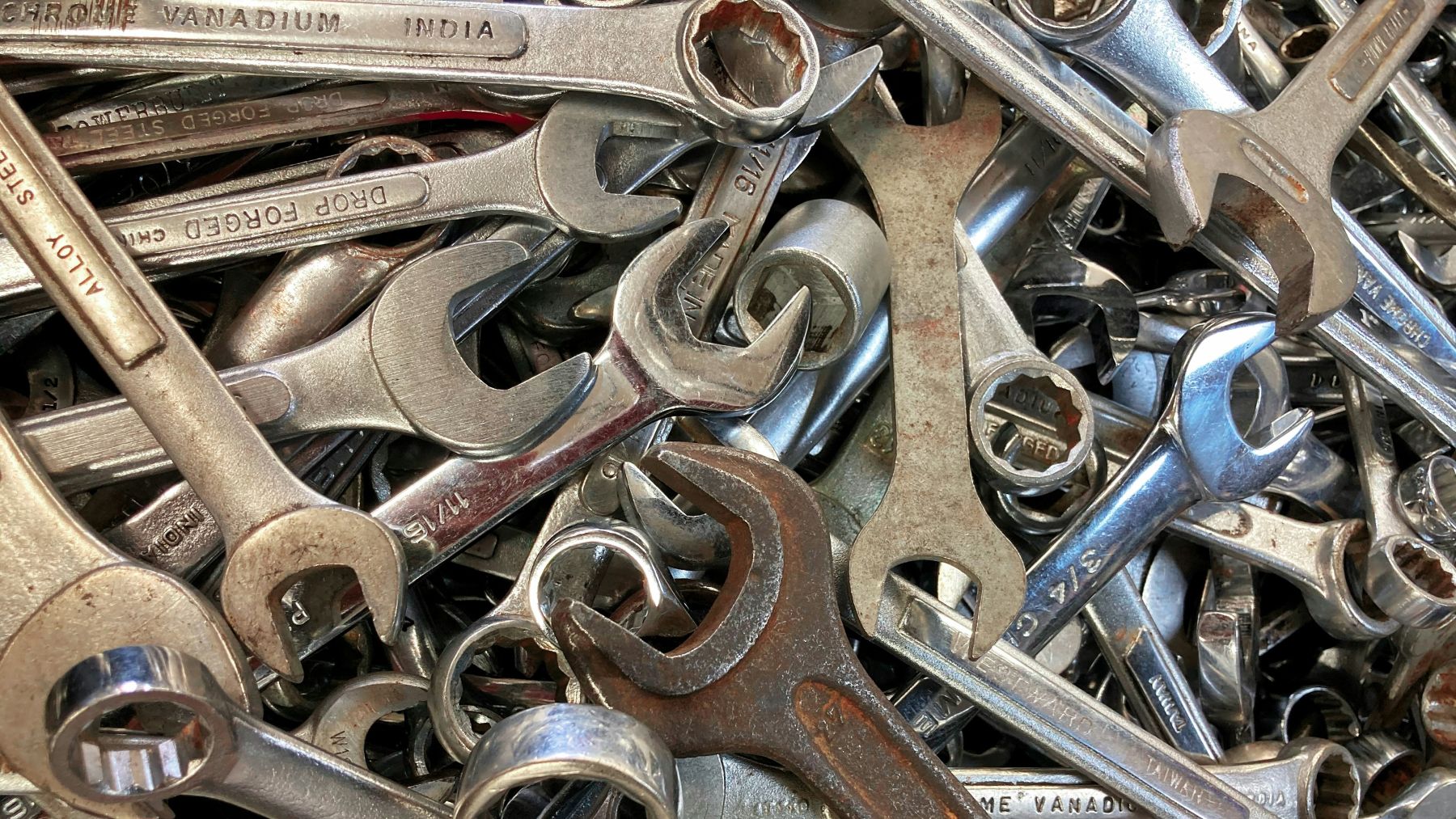 Close up of a pile of wrenches