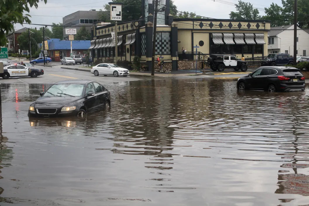 At least three cars stalled in floodwaters at a Hackensack intersection in Tropical Storm Elsa’s wake.