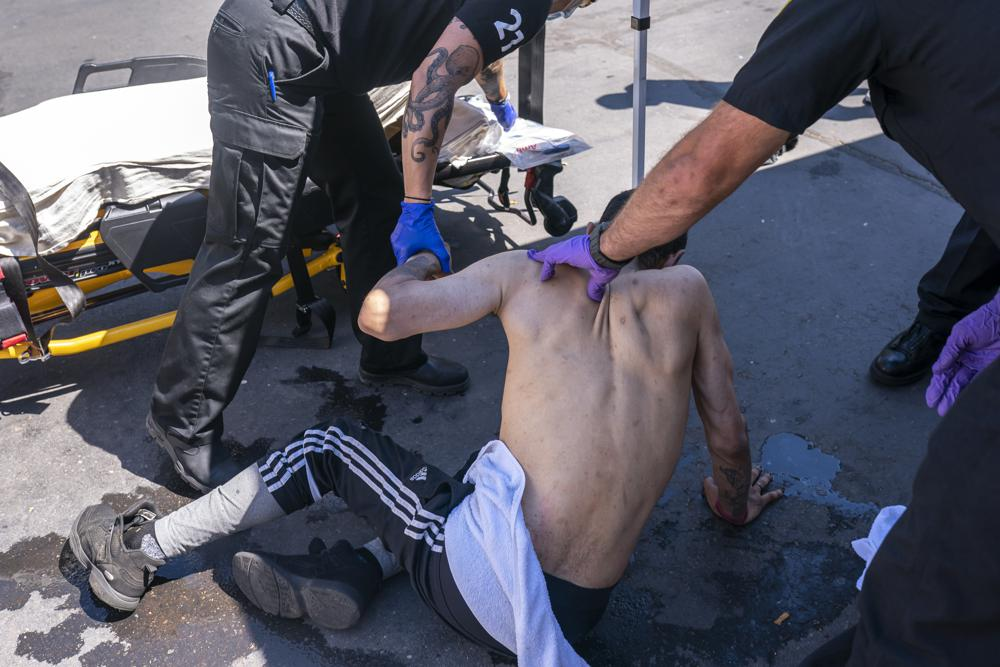 Salem Fire Department paramedics respond to a heat exposure call at a cooling center during a heat wave in Salem, Ore.