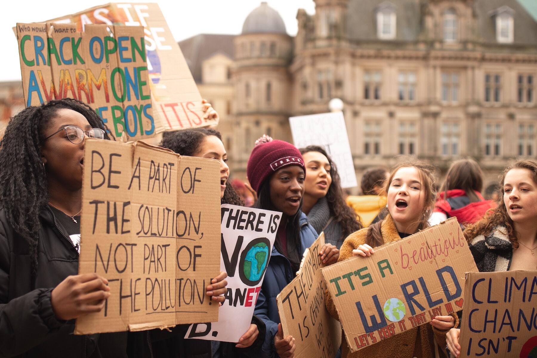 Crowd of young people holding climate signs. 