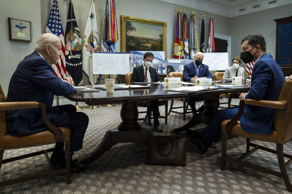 President Joe Biden, joined by Transportation Secretary Pete Buttigieg, attends an infrastructure meeting in the Roosevelt Room, April 7, 2022, at the White House. 