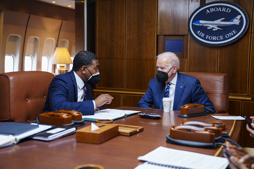 President Joe Biden talks with EPA Administrator Michael Regan aboard Air Force One, Thursday, February 17, 2022.