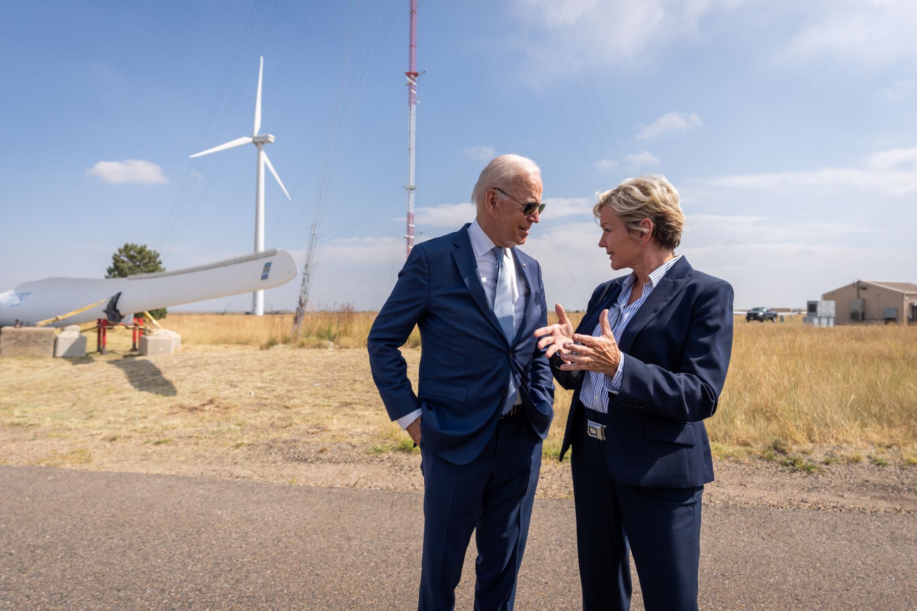 President Biden speaks with Energy Secretary Jennifer Granholm in front of a wind turbine in Colorado.