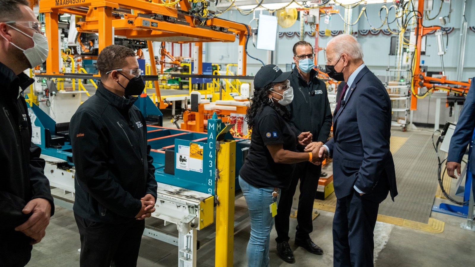 Team Leader Meme Edwards shakes President Biden’s hand after a demonstration at an electric vehicle factory manufacturing facility in Michigan.