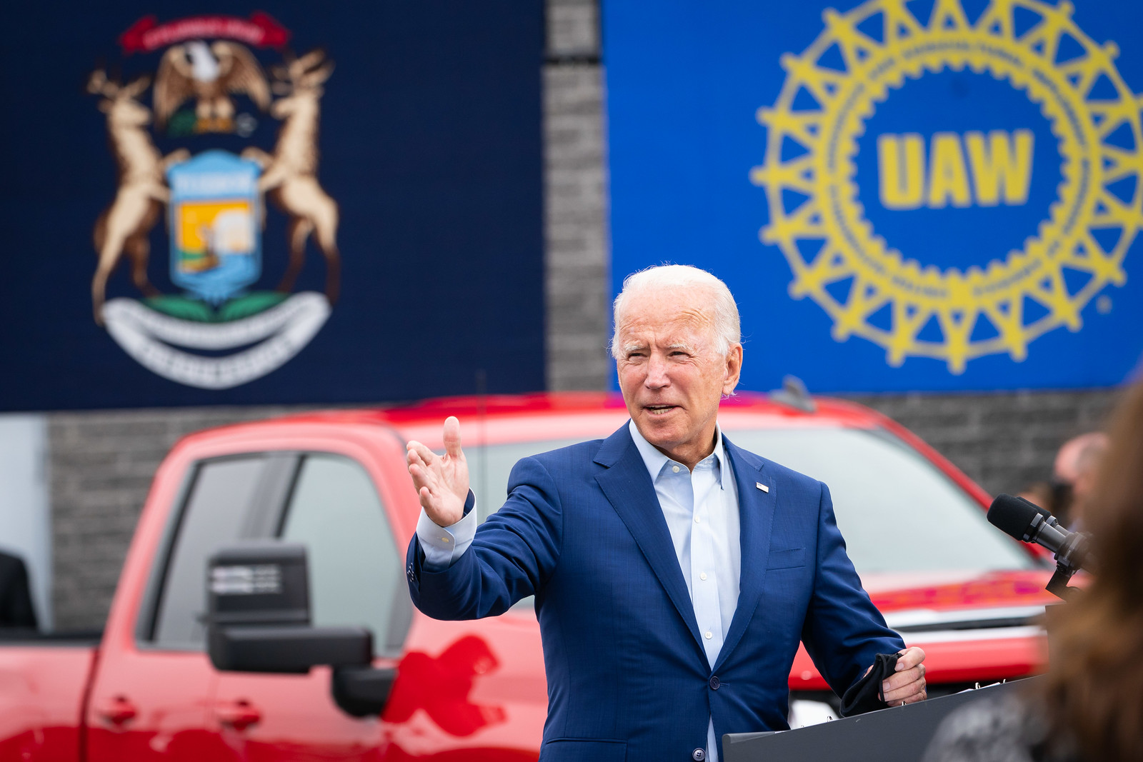 Then presidential candidate Joe Biden speaks at the United Auto Workers Region Hall in Michigan. A banner with the UAW logo is behind him.