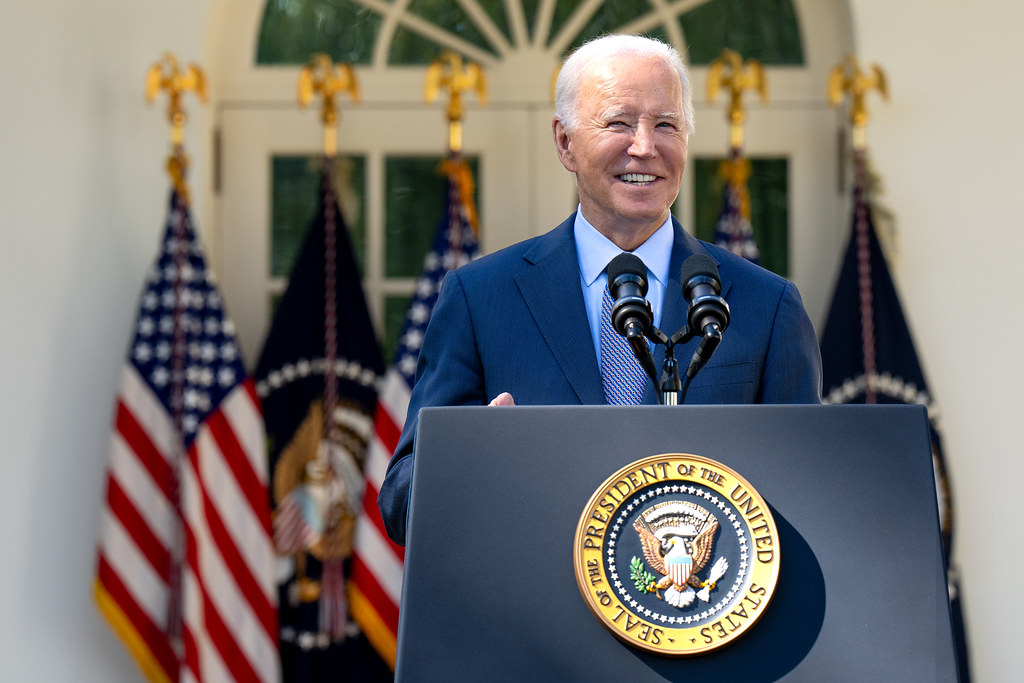 President Biden smiling at the podium