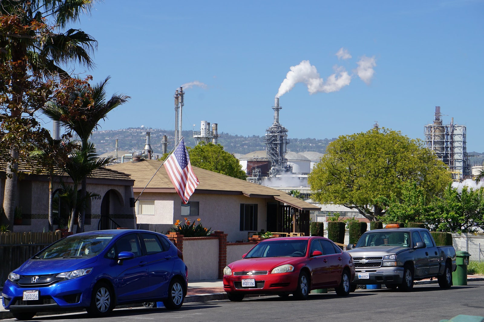 A refinery spewing air pollution directly next to houses.