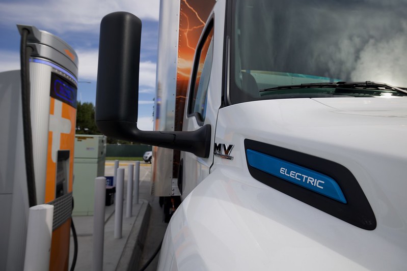 An electric truck charging at a public, direct current (DC) fast charger at a busy truck stop just north of the Otay Mesa Port of Entry in California. 