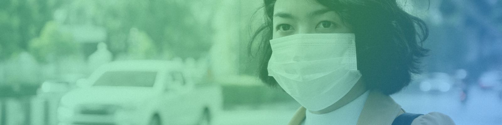 Woman with face mask. A truck can be seen behind her.