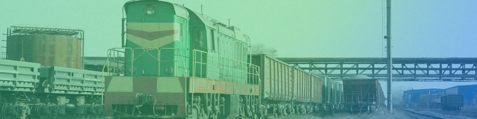 A train carrying shipping containers moving along tracks.