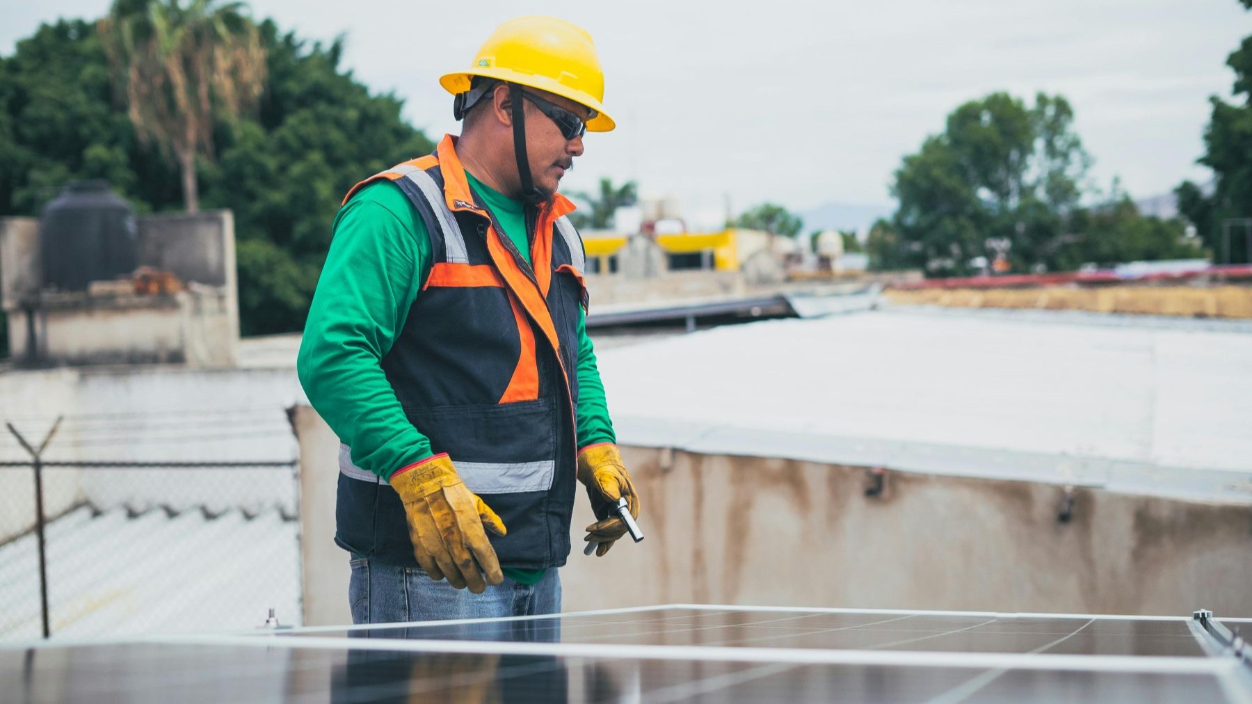 Person in safety equipment working on a solar panel